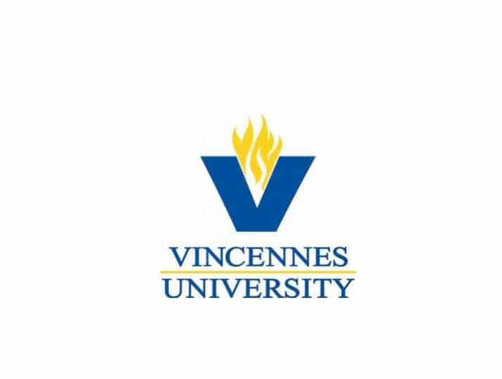 Vincennes University logo featuring a large blue V with a yellow flame above it, and the words Vincennes University in blue text below, separated by a yellow line.