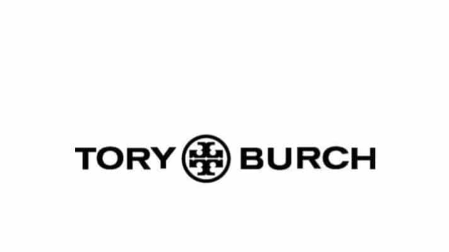 The image shows the Tory Burch logo with TORY and BURCH in bold black letters, separated by a circular emblem featuring a geometric design, all set against a white background.