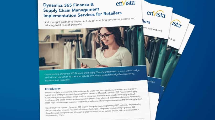 A stack of brochures titled Dynamics 365 Finance & Supply Chain Management Implementation Services for Retailers with a woman looking at a computer screen and clothing in the background, on a blue surface.