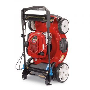 A red and black lawn mower, ideal for garages prioritizing efficient storage, is shown standing upright on its rear wheels. Its underside and blade are visible—perfect for those seeking organized spaces through Supply Chain Network Design & Optimization Services.