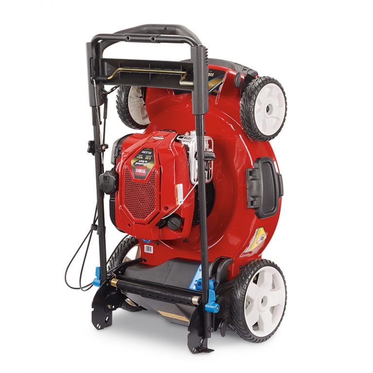 A red and black lawn mower, ideal for garages prioritizing efficient storage, is shown standing upright on its rear wheels. Its underside and blade are visible—perfect for those seeking organized spaces through Supply Chain Network Design & Optimization Services.