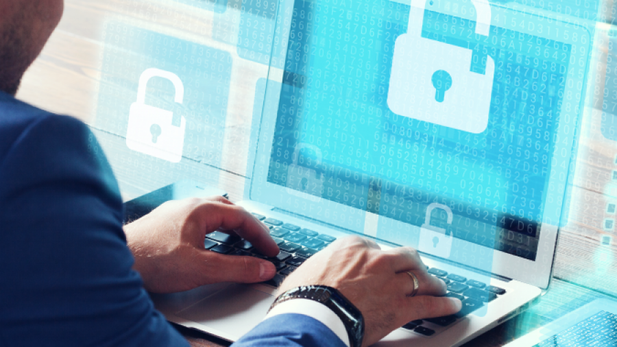 A person uses a laptop displaying a digital padlock symbol, representing cybersecurity or data protection in service desk management, with holographic padlock icons and matrix-style binary code in the background.