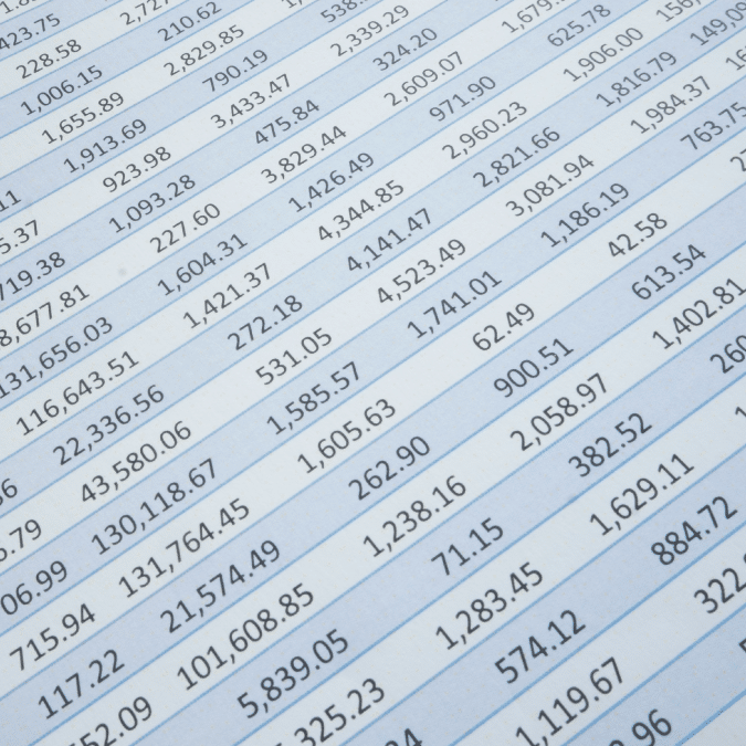 A close-up of a spreadsheet filled with rows and columns of numbers, showing financial or data figures in black text on a white background with blue grid lines.