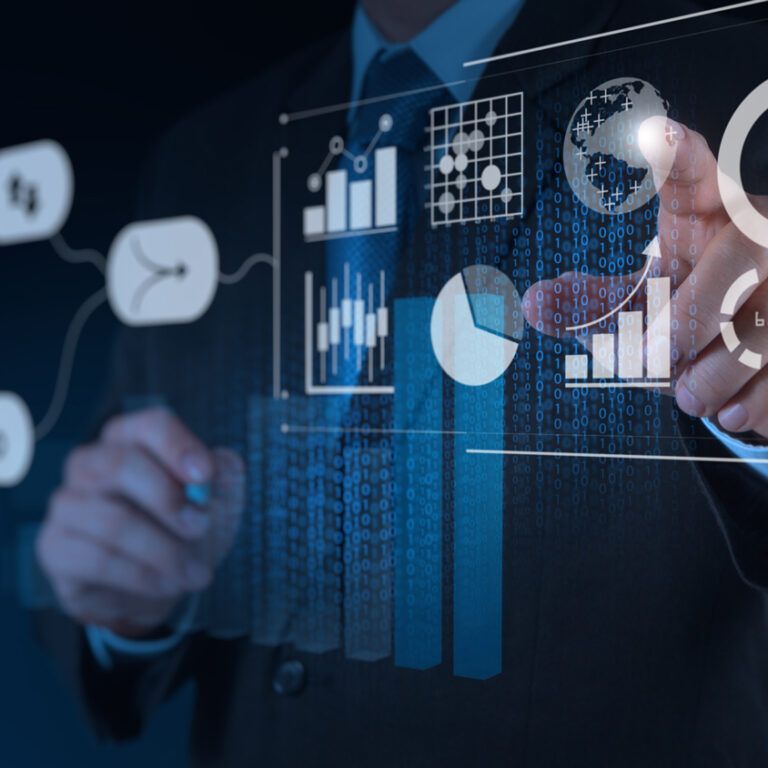 A person in a business suit interacts with virtual data visualizations, including charts, graphs, and circular progress indicators, projecting from a transparent screen in a dark, tech-themed environment.