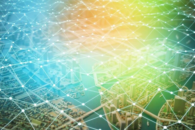 A cityscape seen from above is overlaid with a glowing, interconnected network of lines and nodes, symbolizing digital connectivity, smart city technology, and the seamless integration of the retail supply chain.