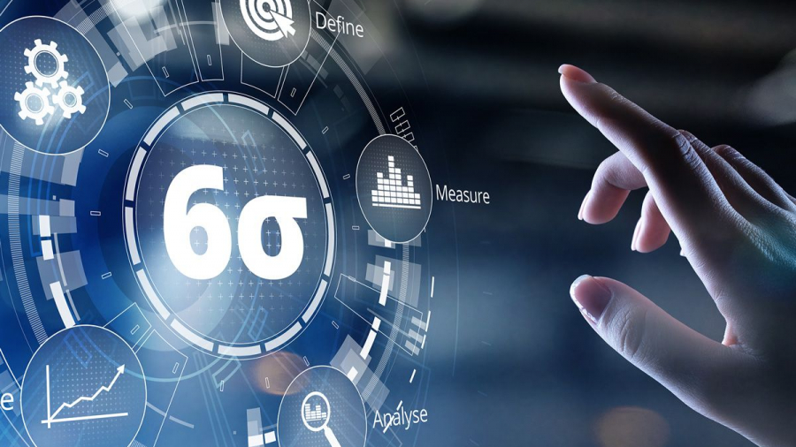 A hand reaches toward a digital interface displaying the Six Sigma symbol (6σ), surrounded by icons and text for stages like Define, Measure, and Apply, highlighting Lean Process Improvements against a blurred background.