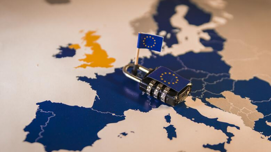 A map of Europe with a padlock and a small European Union flag placed over EU countries; the UK is highlighted in orange, separate from the blue EU countries.