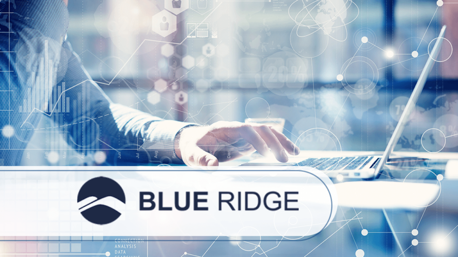 A person’s hand using a laptop with digital data graphics overlaid. In the foreground, a logo with a blue mountain icon and the words Blue Ridge is displayed. The scene conveys technology and business concepts.