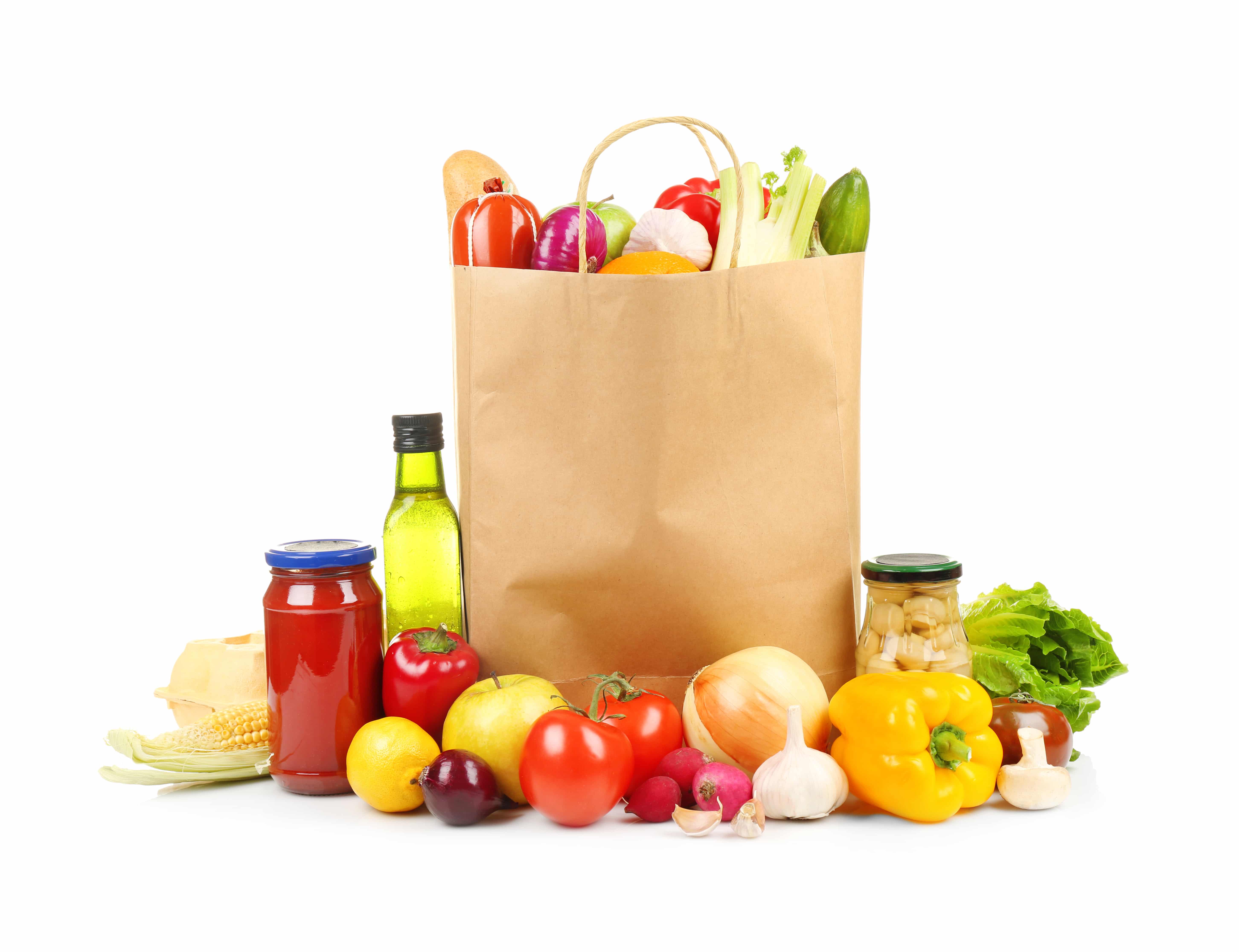 A paper grocery bag filled with fresh vegetables, surrounded by tomatoes, bell peppers, garlic, and more—perfectly arranged to highlight smart distribution consulting for quality produce on a white background.