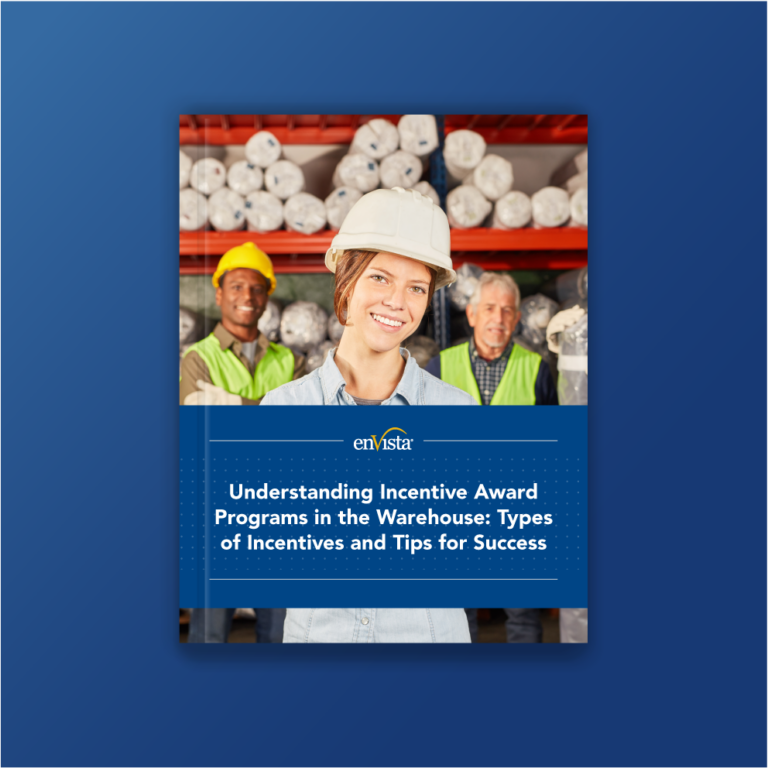 A smiling woman in a hard hat and safety vest stands in a warehouse with two male workers behind her. Text reads: Understanding Incentive Award Programs in the Warehouse: Types of Incentives and Tips for Success.