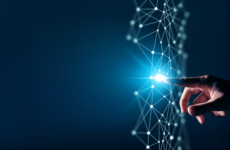 A hand touches a glowing point on a digital network of interconnected lines and nodes, symbolizing technology, connectivity, and the impact of digital transformation consulting against a dark blue background.