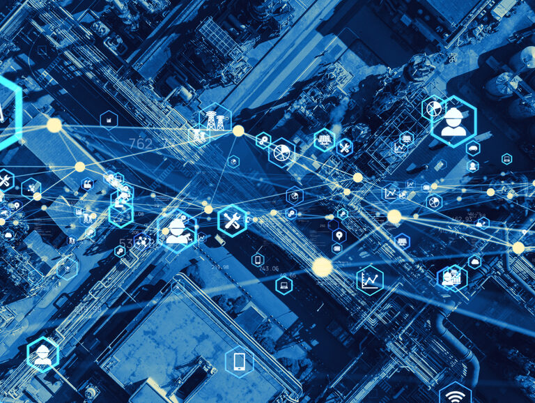 Aerial view of an industrial site overlaid with digital icons and lines representing data, connectivity, and supply chain optimization. The blue tint signifies a modern, connected industrial environment.