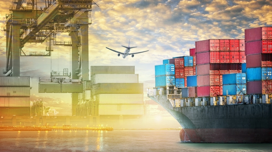 A cargo ship loaded with colorful shipping containers is docked at a port. Overhead cranes move containers, and an airplane flies above, illustrating global trade, logistics, and the efficiency of an agile supply chain.