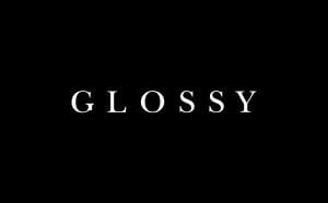 The word GLOSSY is centered in uppercase white letters against a plain black background.
