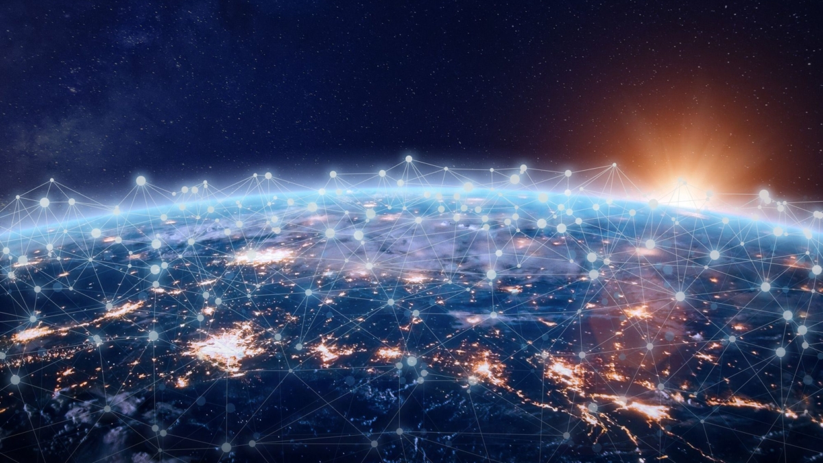 A view of Earth from space at sunrise, with illuminated city lights and a digital network of interconnected glowing points and lines superimposed over the surface, symbolizing global connectivity.