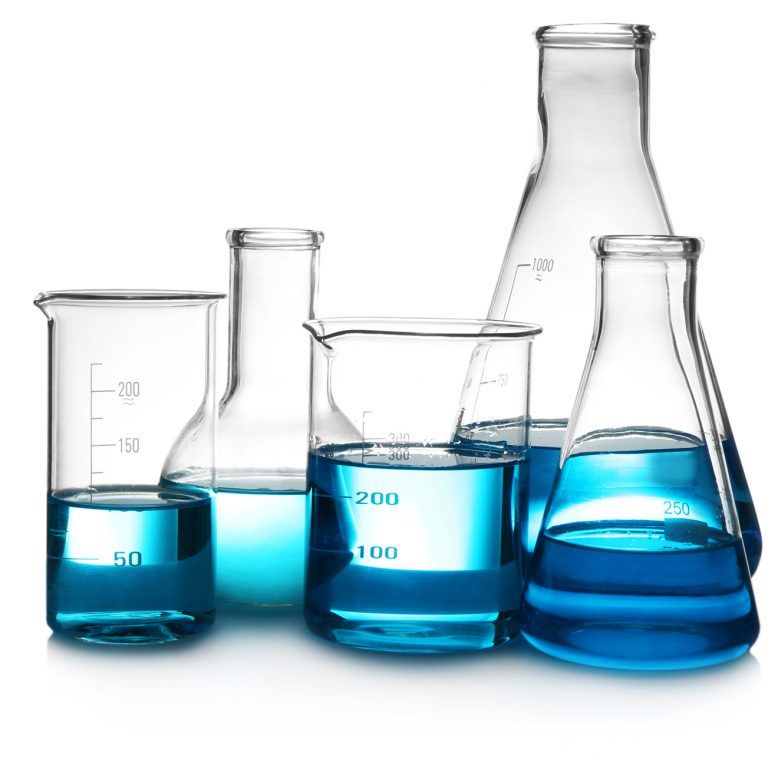 Five glass laboratory flasks and beakers, each filled with varying amounts of blue liquid, are arranged on a white background, symbolizing the precise measurement and analytics found in Dynamics 365 Sales.