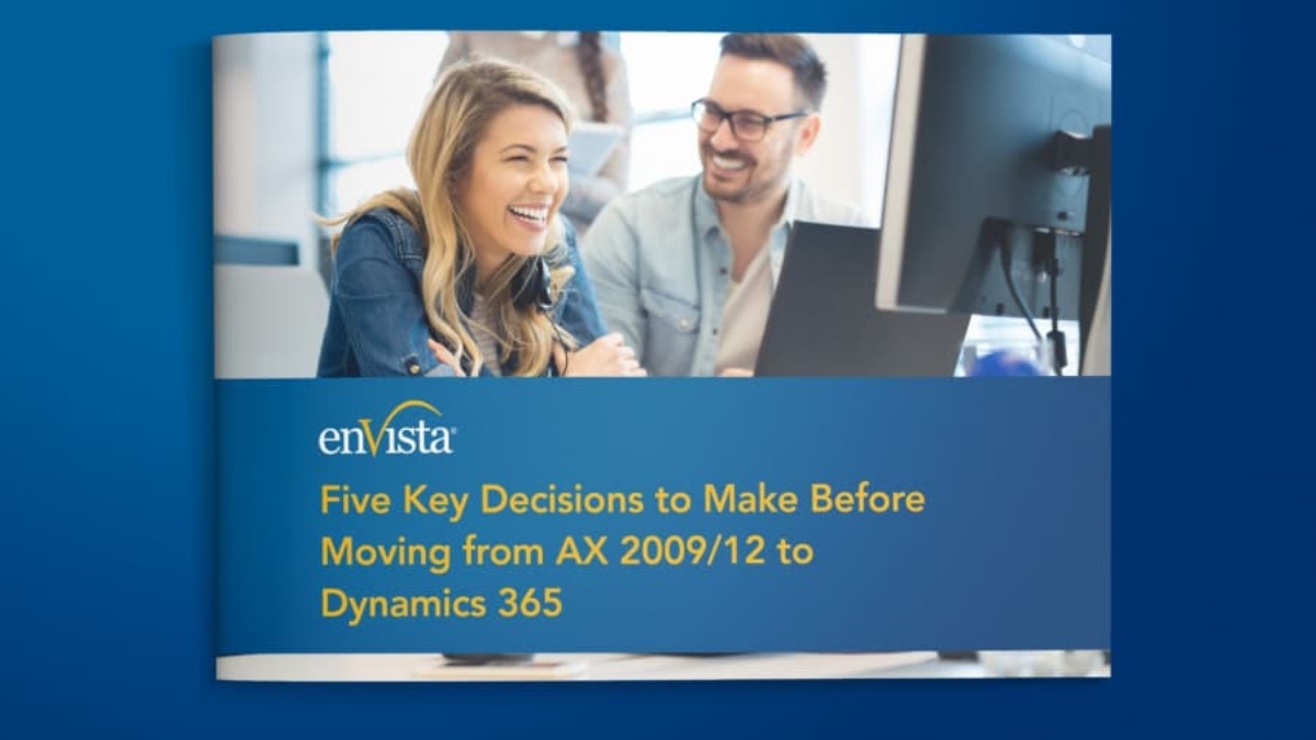 A smiling woman and man sit at a desk with a computer. The text on the image reads: Five Key Decisions to Make Before Moving from AX 2009/12 to Dynamics 365 with the enVista logo above the text.