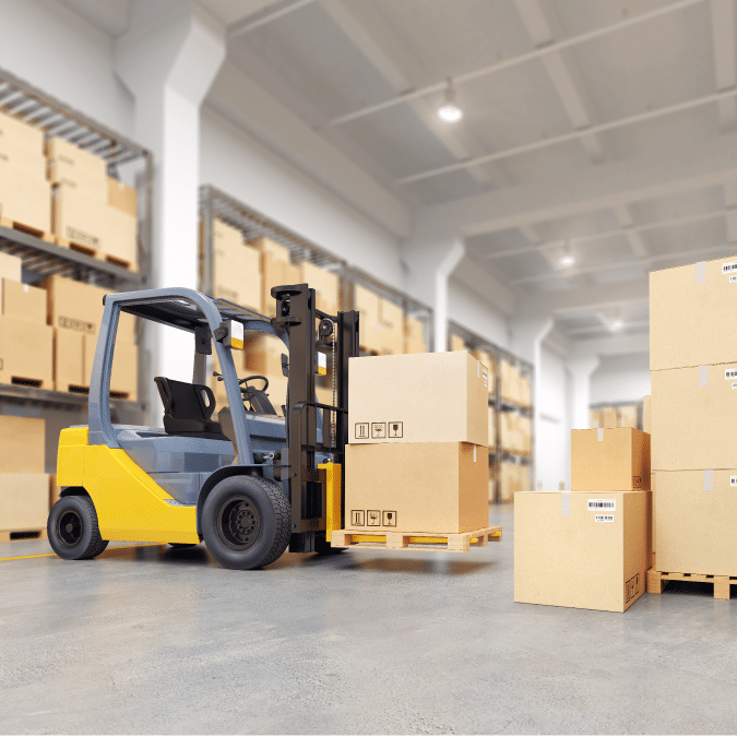 A yellow forklift moves a pallet with cardboard boxes inside a warehouse with shelves stacked with similar boxes.