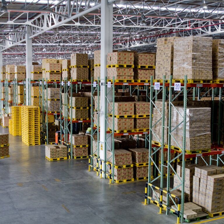 A warehouse with boxes on shelves, efficiently organized by staff working under an incentive based pay system.