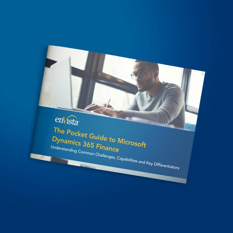 A man wearing glasses works on a laptop near large windows. The image shows a booklet titled The Pocket Guide to Microsoft Dynamics 365 Finance by enVista, with a subtitle about challenges, capabilities, and differentiators.