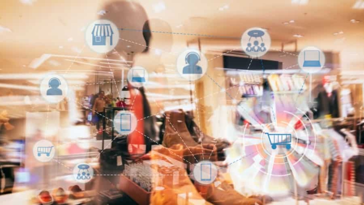A blurred retail store with shoes and clothes displays, overlaid with digital shopping icons like a shopping cart, store, and user profiles, representing online and in-store shopping integration.