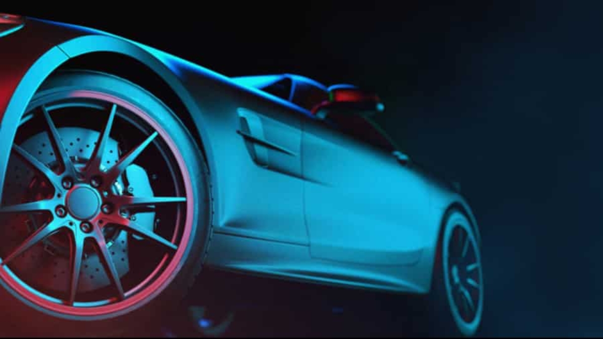 Close-up, low-angle view of a sleek, modern sports car with dramatic blue and red lighting highlighting the rear wheel, brake discs, and smooth side body—an image embodying the precision of advanced automation strategies against a dark background.