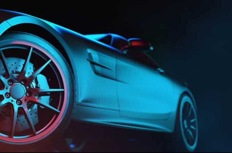 Close-up, low-angle view of a sleek, modern sports car with dramatic blue and red lighting highlighting the rear wheel, brake discs, and smooth side body—an image embodying the precision of advanced automation strategies against a dark background.