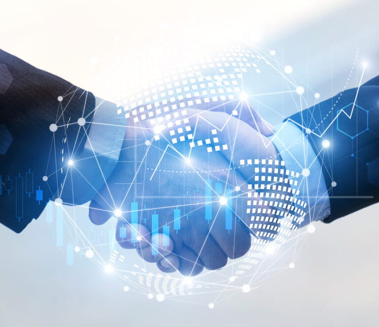 Two people in business suits shaking hands, with a digital globe and network-style graphics overlayed, symbolizing global business, partnership, and technology.