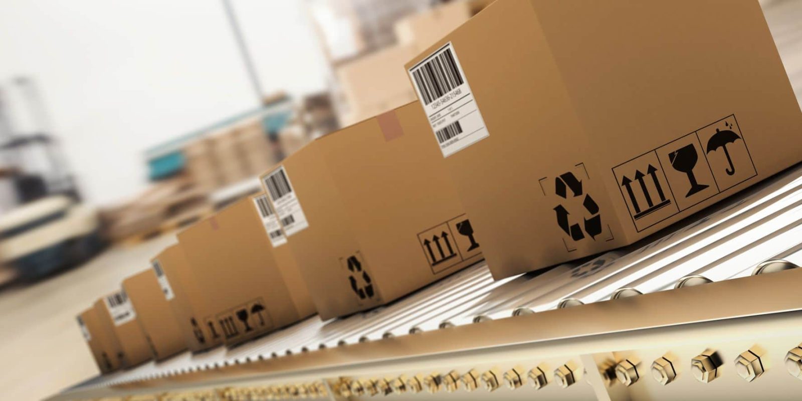 Several cardboard boxes with barcodes and shipping symbols move along a conveyor belt in a warehouse or distribution center, suggesting a shipping or logistics process.