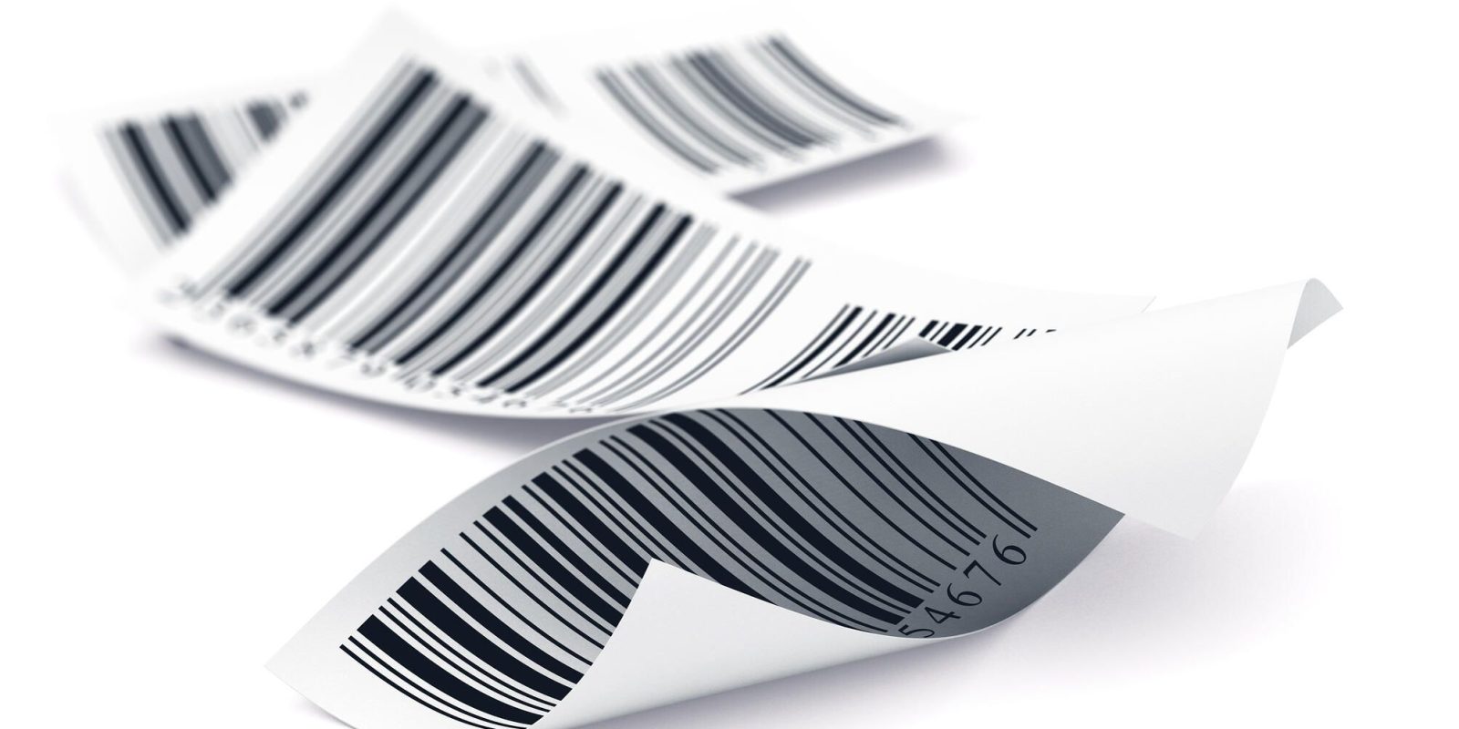 Three curled, white paper receipts with black barcodes are lying on a white surface, overlapping slightly.